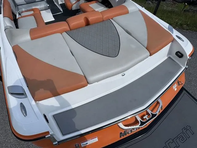 Slide: The Image of 2012 MasterCraft X-35 boat with orange and gray seating, rear view. - 23