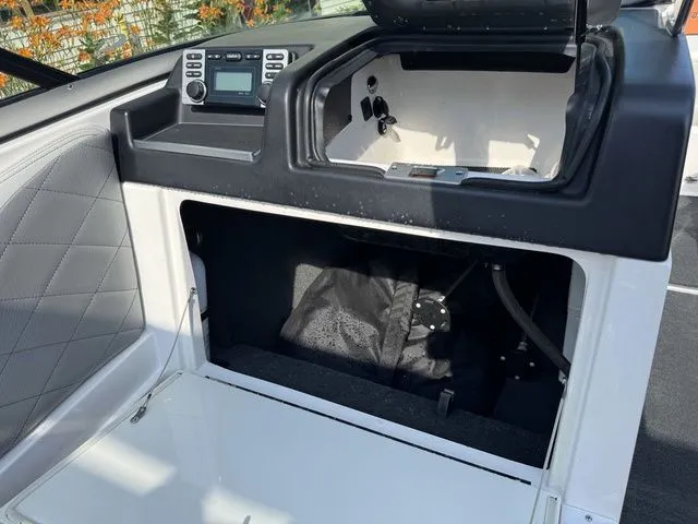 Slide: The Image of 2012 MasterCraft X-35 boat interior with storage compartment and control panel. - 30