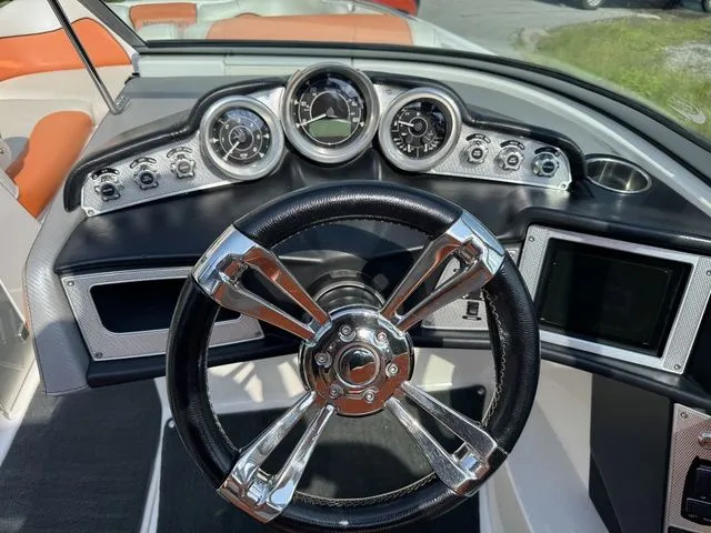 Slide: The Image of Dashboard of a 2012 MasterCraft X-35 boat with chrome steering wheel and gauges. - 32