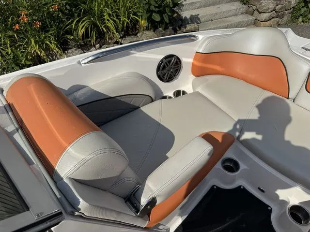 Slide: The Image of 2012 MasterCraft X-35 boat interior with orange and white seating, featuring a speaker and cup holders. - 35