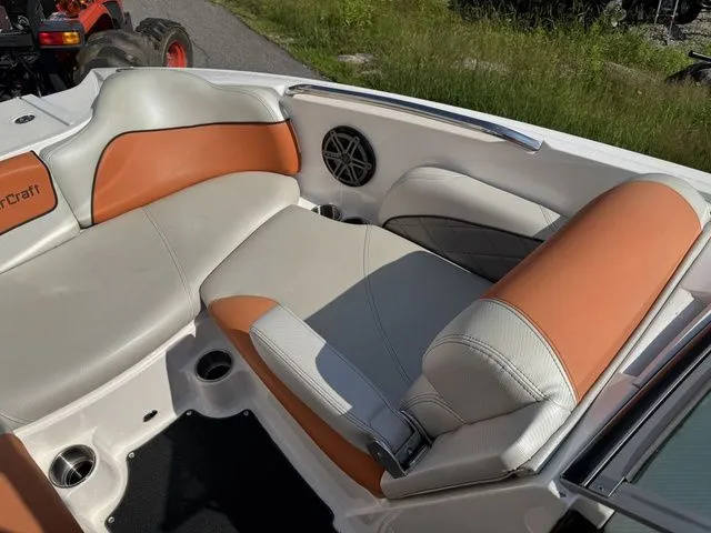Slide: The Image of 2012 MasterCraft X-35 boat interior with orange and gray seating, speaker, and cup holders. - 36