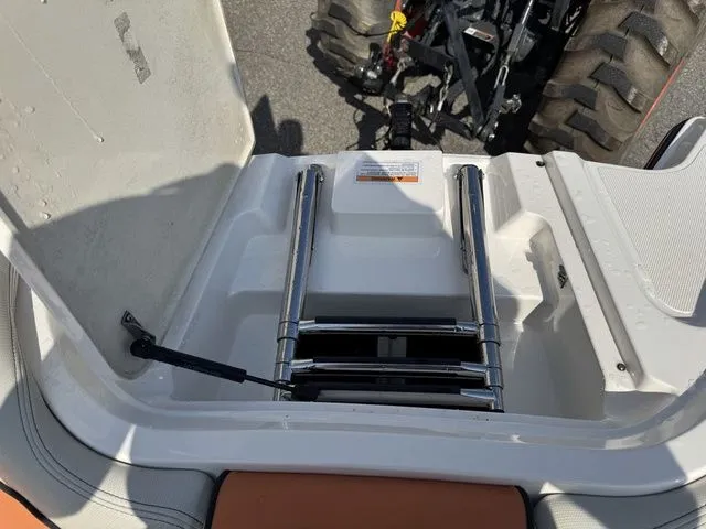 Slide: The Image of 2012 MasterCraft X-35 boat ladder and storage compartment, with tractor in background. - 37