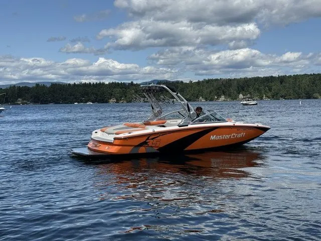 Slide: The Image of 2012 MasterCraft X-35 boat on a lake with scenic forest background. - 7