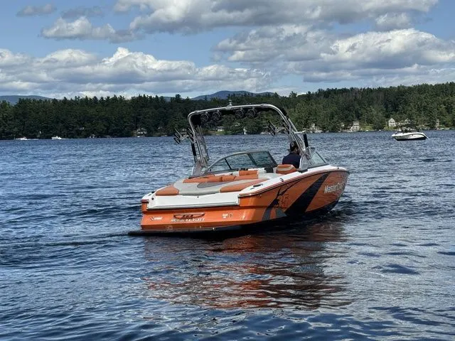 Slide: The Image of 2012 MasterCraft X-35 boat on a lake with scenic forested shoreline. - 9