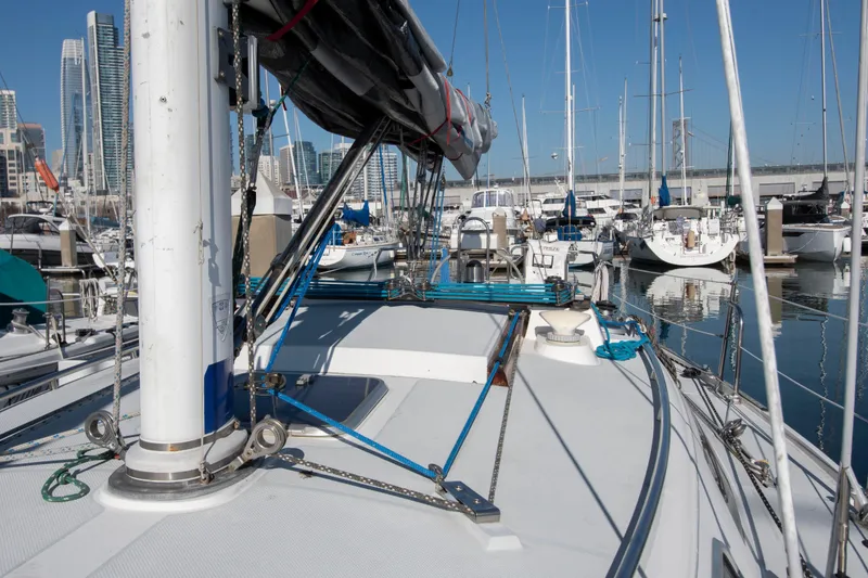 Slide: The Image of Sailboat Catalina 34 MK 1.5, 1993 model, docked in a marina with city skyline. - 14