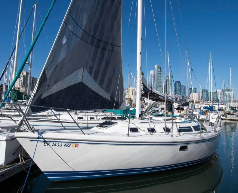 Slide: The Image of 1993 Catalina 34 MK 1.5 sailboat docked in marina with city skyline background. - 15