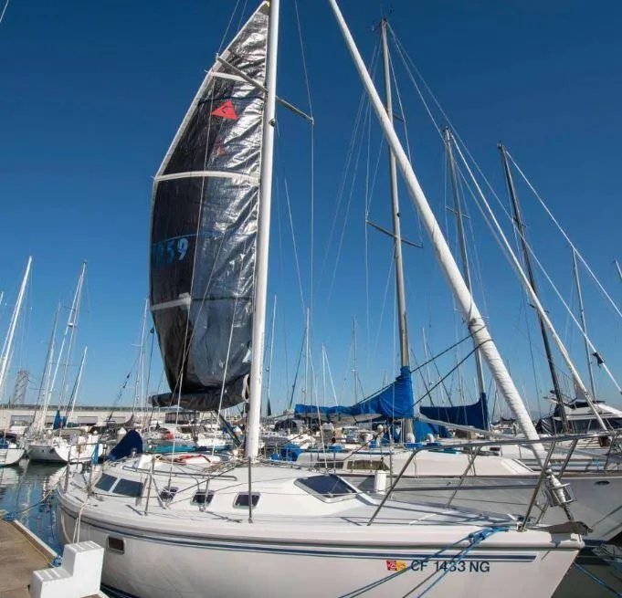 Slide: The Image of 1993 Catalina 34 MK 1.5 sailboat docked in marina under clear blue sky. - 16