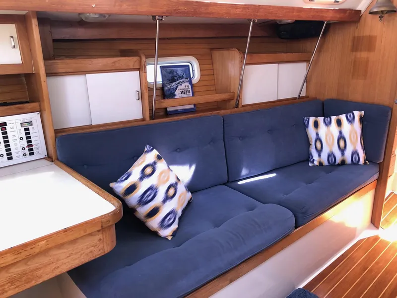 Slide: The Image of Cozy interior of 1993 Catalina 34 MK 1.5 sailboat with blue cushions and patterned pillows. - 2