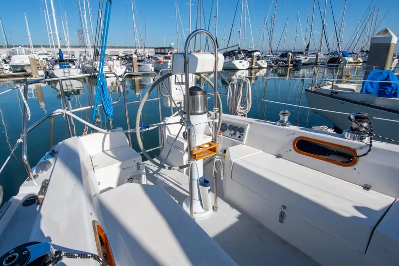 Slide: The Image of 1993 Catalina 34 MK 1.5 sailboat cockpit in marina, surrounded by docked boats. - 20