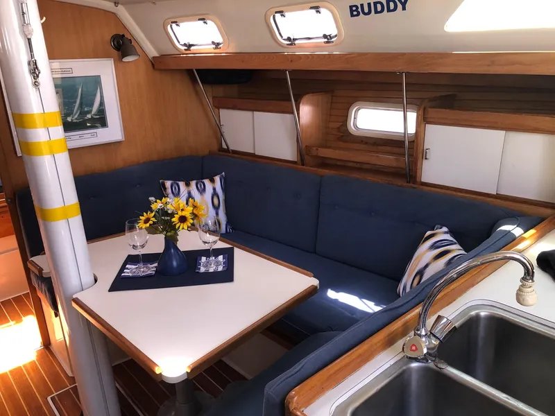 Slide: The Image of Cozy interior of 1993 Catalina 34 MK 1.5 sailboat with blue seating and dining area. - 3
