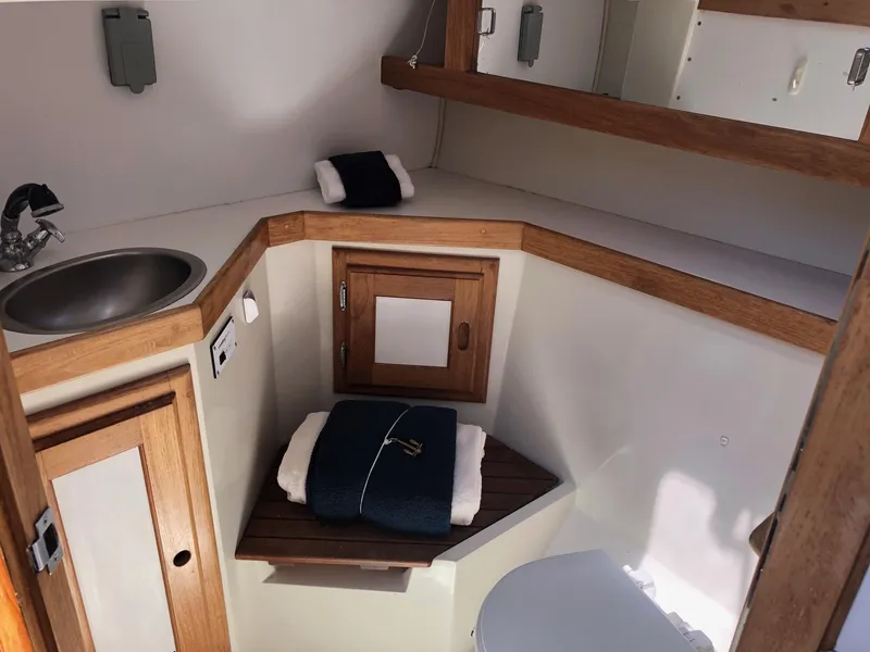 Slide: The Image of Interior of 1993 Catalina 34 MK 1.5 sailboat bathroom with sink and wooden accents. - 7