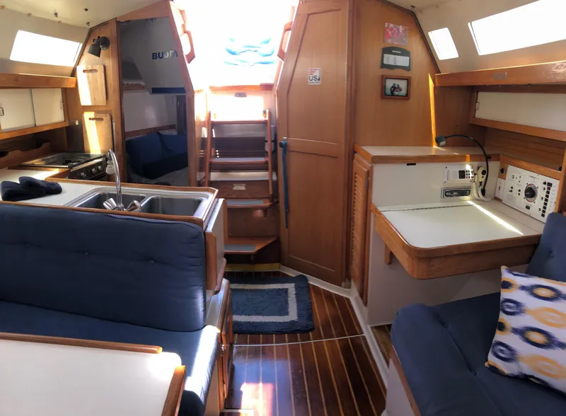 Slide: The Image of Interior of 1993 Catalina 34 MK 1.5 sailboat with cozy seating and wooden finishes. - 9