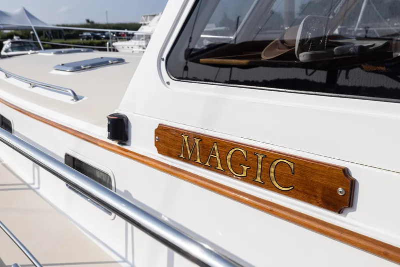 Slide: The Image of 2005 Grand Banks Eastbay 43 HX yacht with "Magic" nameplate, sleek design. - 14
