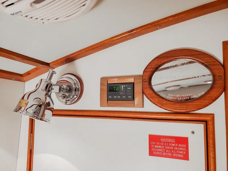 Slide: The Image of Interior of 2005 Grand Banks Eastbay 43 HX with light fixture and control panel. - 21