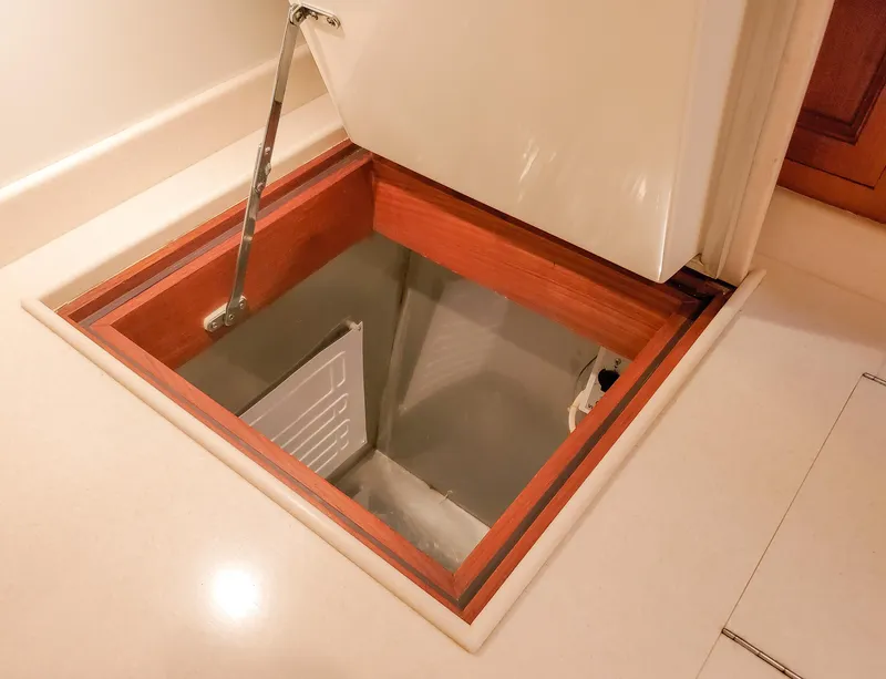 Slide: The Image of Access hatch on 2005 Grand Banks Eastbay 43 HX yacht, showcasing interior storage space. - 27