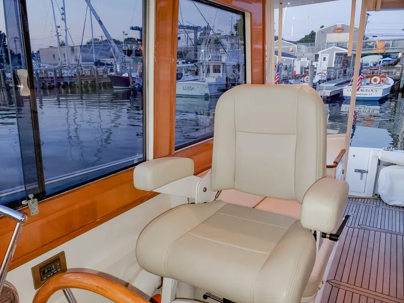 Slide: The Image of Captain's chair on 2005 Grand Banks Eastbay 43 HX yacht, overlooking marina. - 3