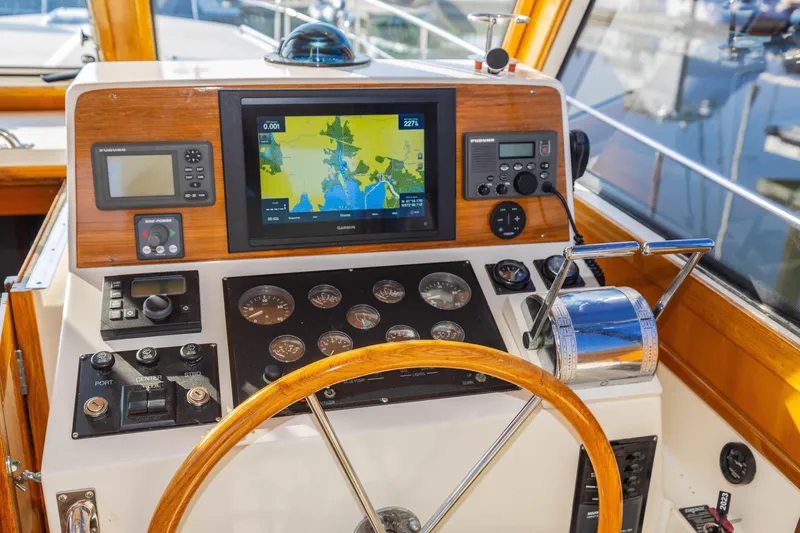 Slide: The Image of Helm of 2005 Grand Banks Eastbay 43 HX with navigation instruments and wooden steering wheel. - 6