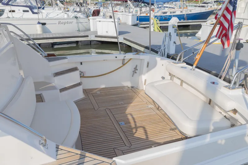 Slide: The Image of 2005 Grand Banks Eastbay 43 HX yacht with spacious teak deck and seating area. - 9