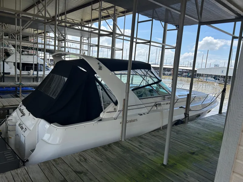 The Image of 1997 Cruisers Yachts 3575 Esprit docked under a covered marina with clear skies. - 0