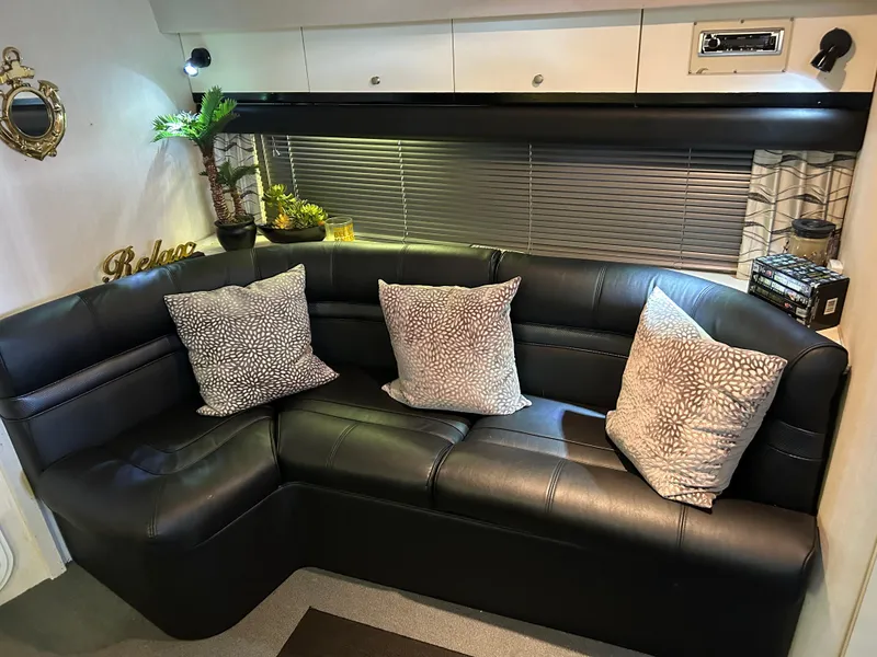 Slide: The Image of Luxurious interior of 1997 Cruisers Yachts 3575 Esprit with black leather seating and decorative pillows. - 21