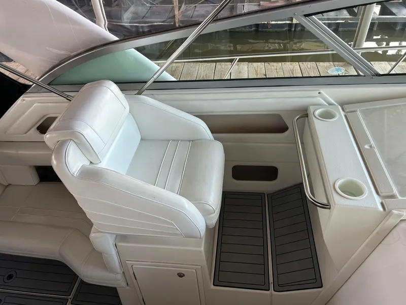 Slide: The Image of 1997 Cruisers Yachts 3575 Esprit cockpit with white seating and cup holders. - 23