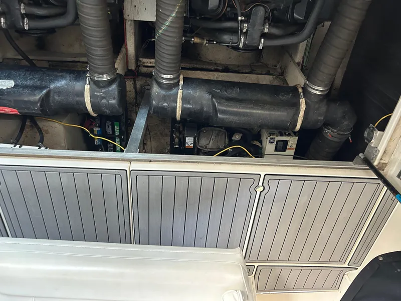 Slide: The Image of Engine compartment of a 1997 Cruisers Yachts 3575 Esprit, showing hoses and battery setup. - 9