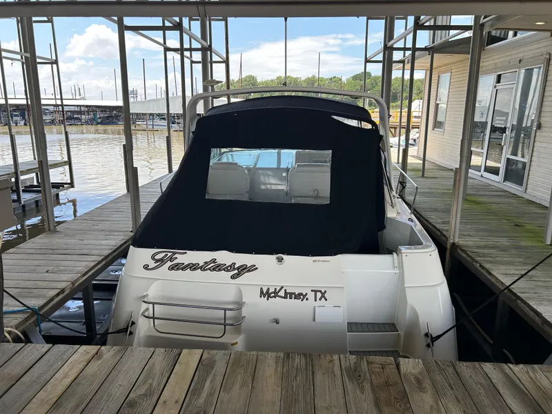 Slide: The Image of 1997 Cruisers Yachts 3575 Esprit docked at marina, rear view with cover. - 2