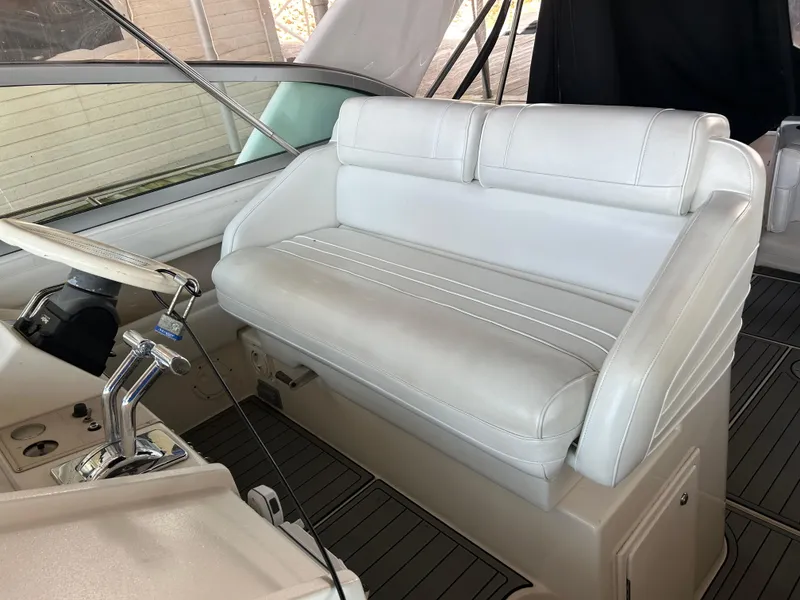 Slide: The Image of 1997 Cruisers Yachts 3575 Esprit helm with white leather seating and steering controls. - 24