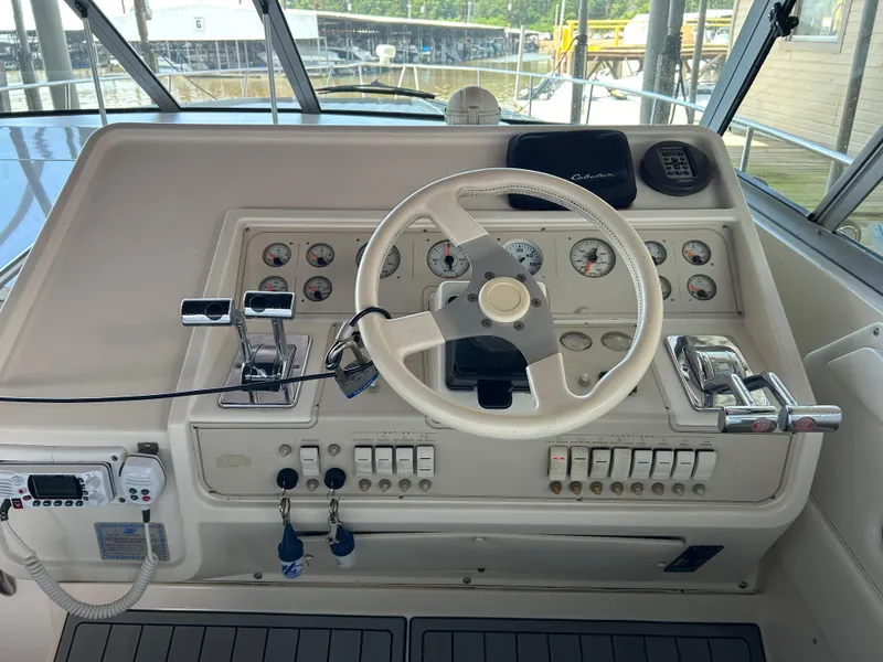Slide: The Image of 1997 Cruisers Yachts 3575 Esprit helm with steering wheel and control panel. - 25