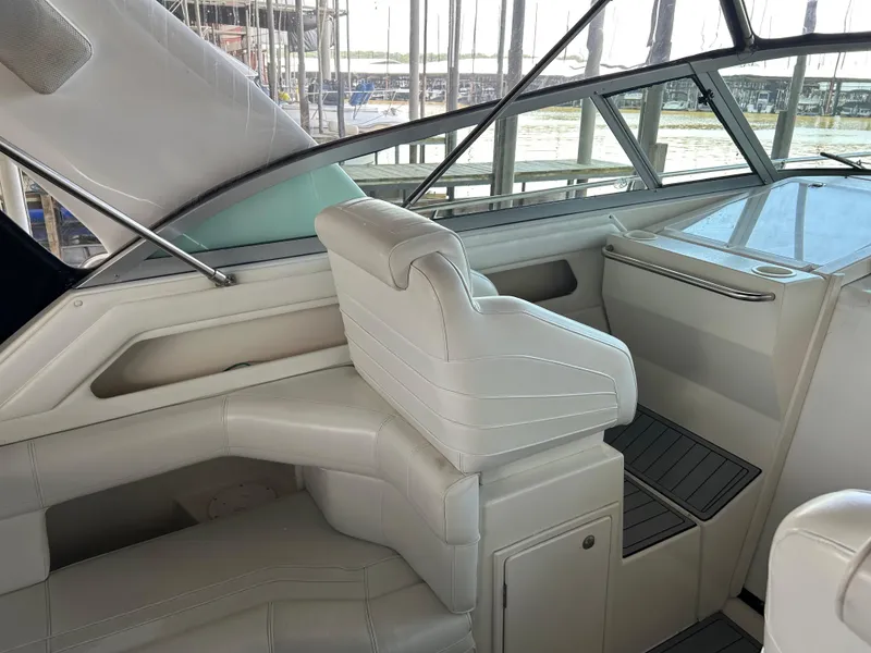 Slide: The Image of 1997 Cruisers Yachts 3575 Esprit interior with white seating and helm, docked at marina. - 27