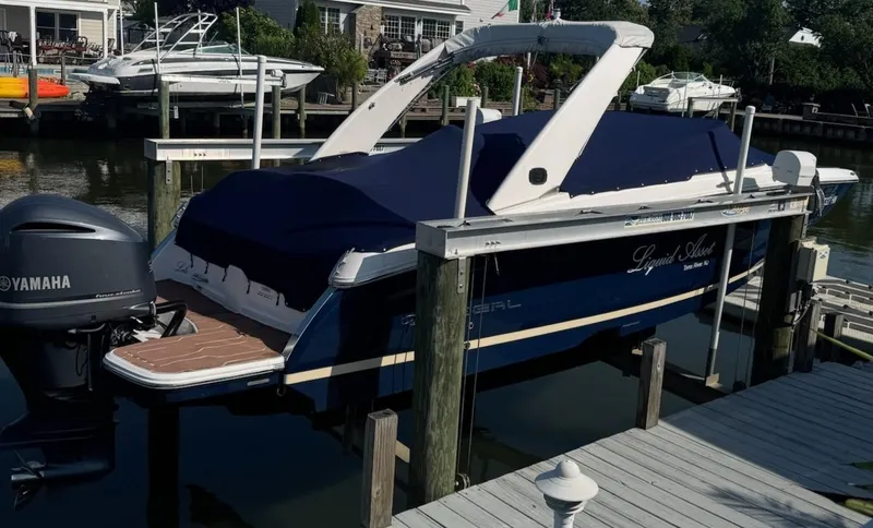 The Image of 2019 Regal 26 OBX boat docked with Yamaha outboard motor, covered and elevated. - 0