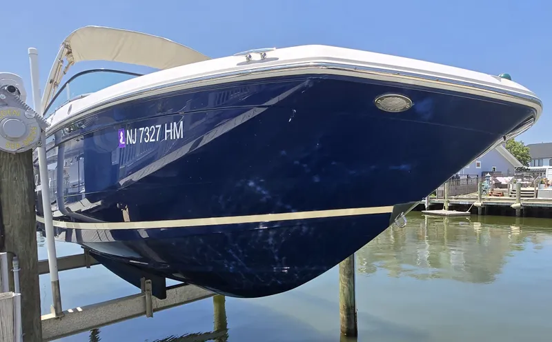 Slide: The Image of 2019 Regal 26 OBX boat docked, blue hull, registration NJ7327HM, sunny day. - 13