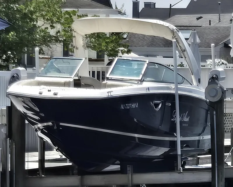 Slide: The Image of 2019 Regal 26 OBX boat docked, featuring sleek design and modern amenities. - 14
