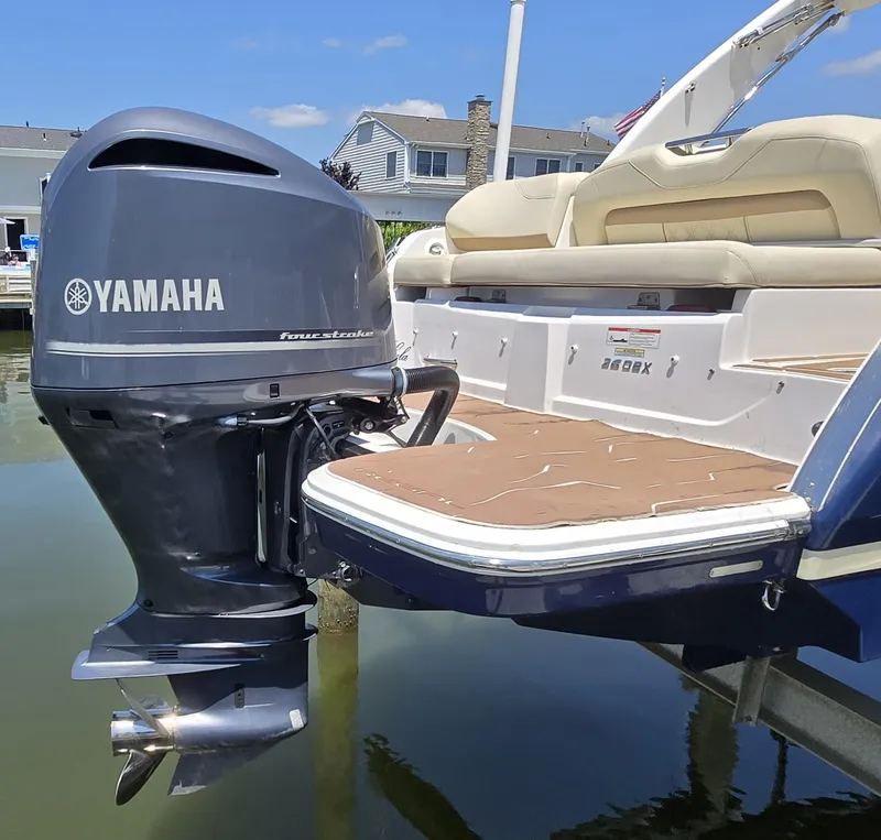 Slide: The Image of 2019 Regal 26 OBX boat with Yamaha outboard motor, docked near waterfront homes. - 15