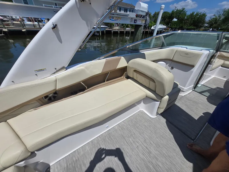 Slide: The Image of 2019 Regal 26 OBX boat interior with beige seating and waterfront view. - 9