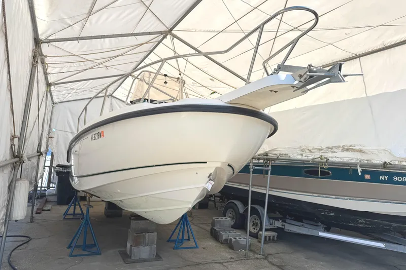 Slide: The Image of 1999 Boston Whaler 21 Outrage boat stored in a covered facility. - 1