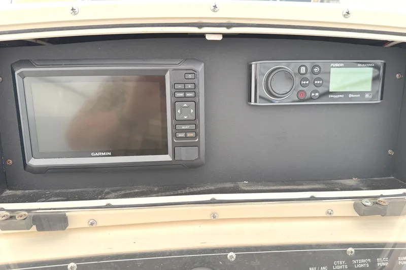 Slide: The Image of Garmin and Fusion marine electronics on 1999 Boston Whaler 21 Outrage dashboard. - 10