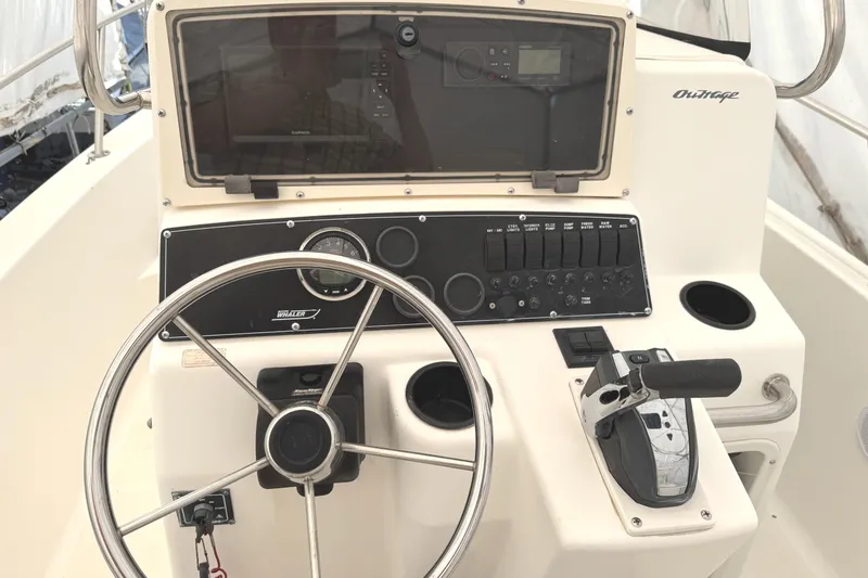 Slide: The Image of 1999 Boston Whaler 21 Outrage boat console with steering wheel and control panel. - 11