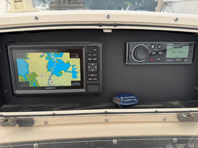 Slide: The Image of Dashboard of a 1999 Boston Whaler 21 Outrage with Garmin GPS and Fusion radio. - 12