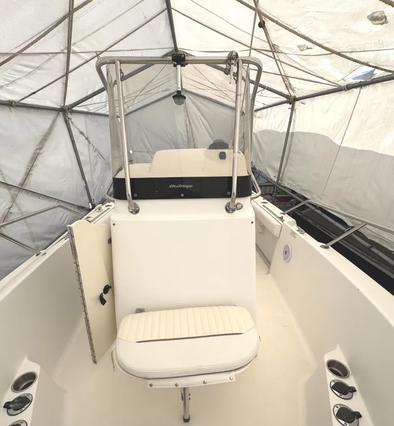 Slide: The Image of 1999 Boston Whaler 21 Outrage boat interior under protective cover. - 14