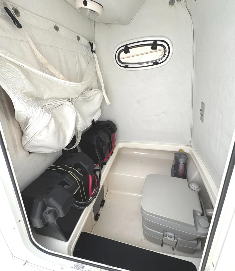 Slide: The Image of Interior of a 1999 Boston Whaler 21 Outrage boat, featuring storage and equipment. - 15