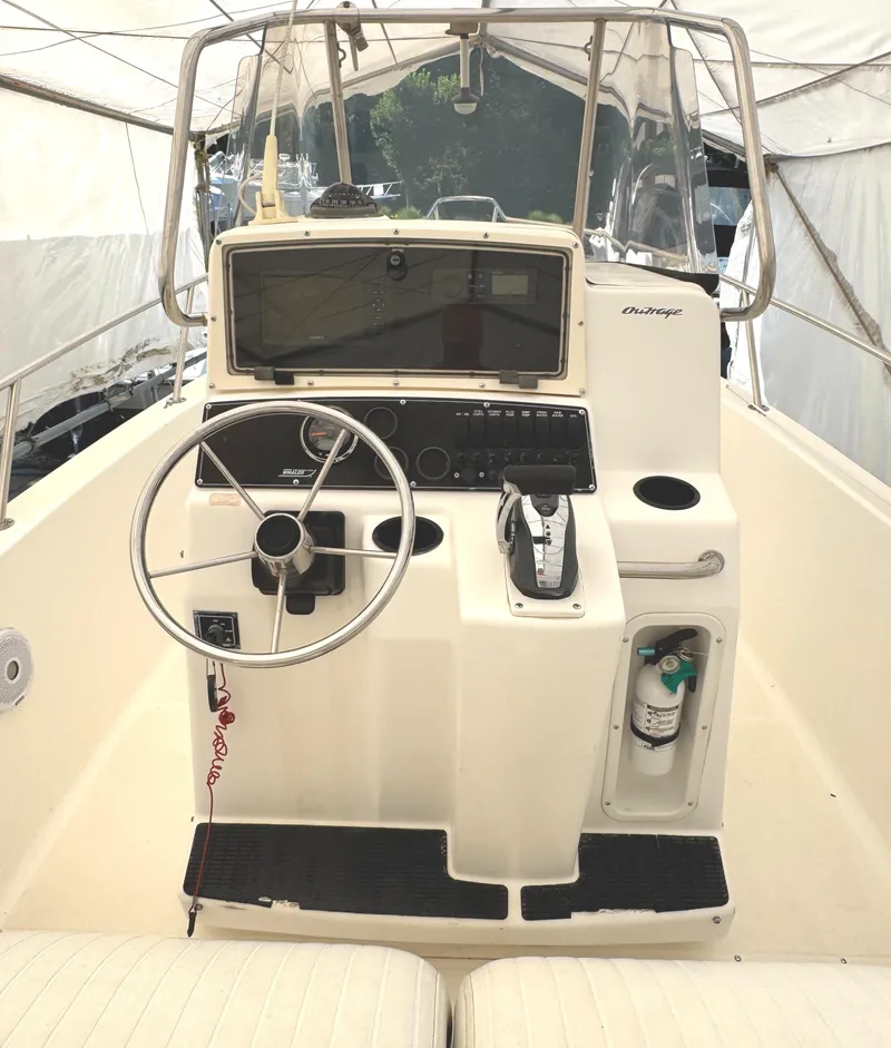 Slide: The Image of 1999 Boston Whaler 21 Outrage boat console with steering wheel and controls. - 4