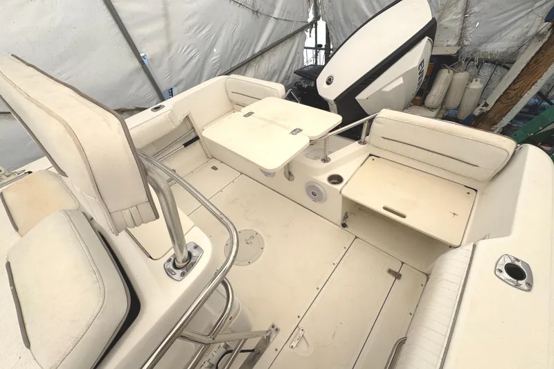Slide: The Image of 1999 Boston Whaler 21 Outrage boat interior with seating and storage compartments. - 6