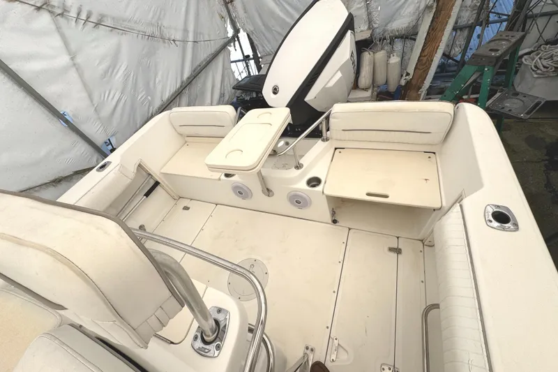 Slide: The Image of 1999 Boston Whaler 21 Outrage boat interior with seating and storage compartments. - 7