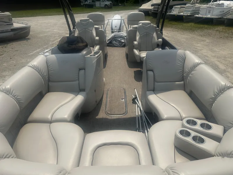 Slide: The Image of 2016 Manitou 25 Legacy SRS pontoon boat with luxurious seating and cup holders. - 10