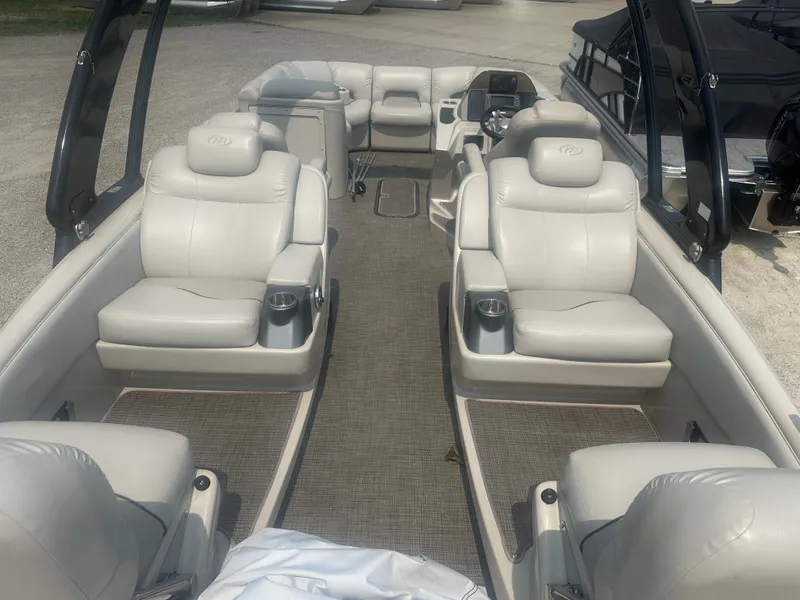 Slide: The Image of 2016 Manitou 25 Legacy SRS pontoon boat interior with luxurious seating and modern design. - 2