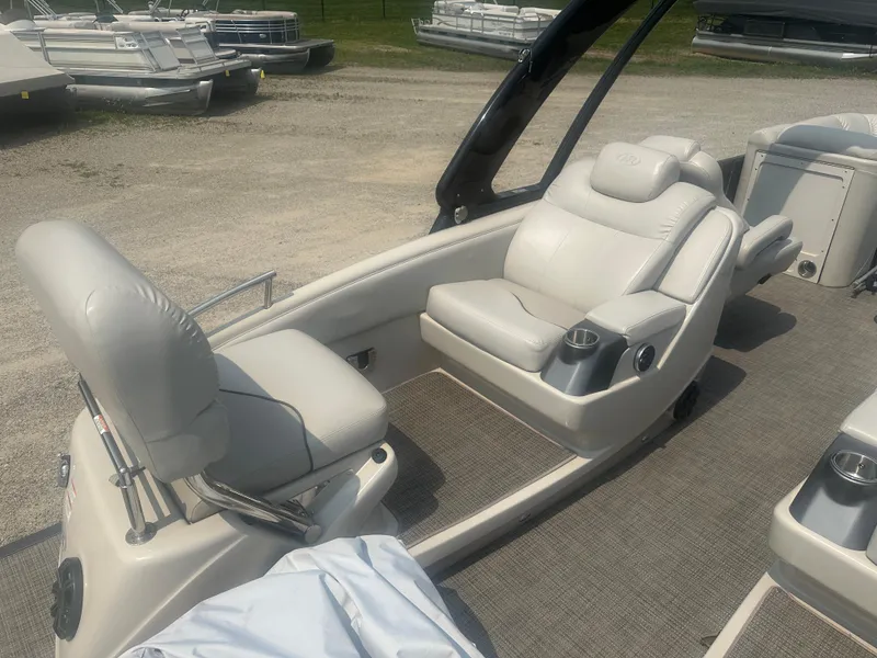 Slide: The Image of 2016 Manitou 25 Legacy SRS boat interior with plush seating and cup holders. - 3