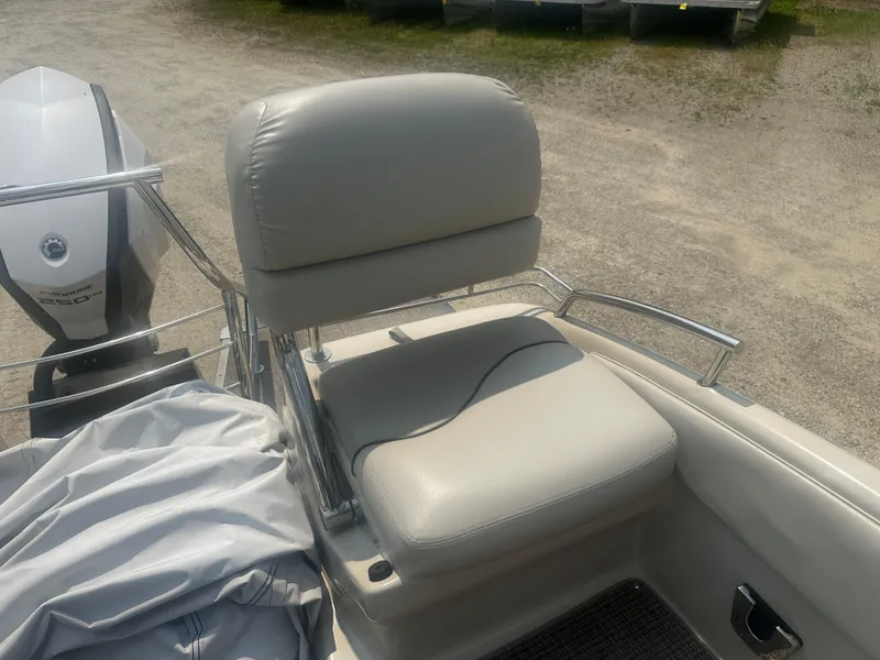 Slide: The Image of 2016 Manitou 25 Legacy SRS boat seat with outboard motor in background. - 7