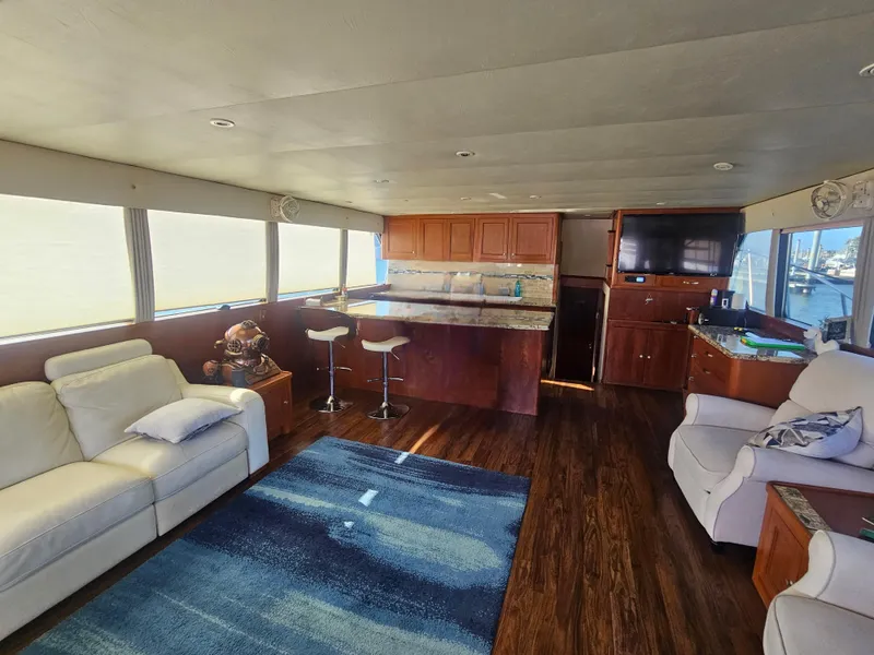 Slide: The Image of Luxurious interior of 2001 Darling Yachts 62 Enclosed Bridge with modern furnishings and wood flooring. - 6