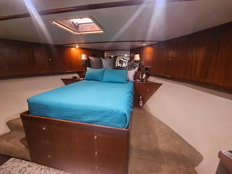 Slide: The Image of Luxurious bedroom interior of 2001 Darling Yachts 62 Enclosed Bridge with blue bedding. - 8